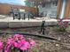 Patio with outdoor grill, seating, fire pit, and beautiful landscaping with flower beds at 4353 Wolff St, Denver, CO 80212