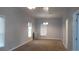 A spacious living room featuring large windows, plush carpet, and neutral paint at 4353 Wolff St, Denver, CO 80212