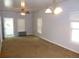 Bright living area with carpet flooring, a ceiling fan, and ample natural light streaming through the windows at 4353 Wolff St, Denver, CO 80212