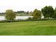 Green grassy park area with a lake and trees, featuring a view of buildings in the distance at 4353 Wolff St, Denver, CO 80212