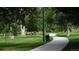 Paved walking path through a green park with mature trees, lawn and shrubbery at 4353 Wolff St, Denver, CO 80212