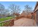 Back deck overlooking a large fenced backyard with mature trees and foliage, adding privacy to the home at 10102 W Ida Ave # 214, Littleton, CO 80127