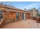A multi-level wood deck shows access to the home, featuring stairs and railing at 10102 W Ida Ave # 214, Littleton, CO 80127