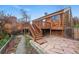Backyard patio featuring natural stone work and access to a upper wood deck at 10102 W Ida Ave # 214, Littleton, CO 80127