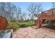 Backyard patio featuring natural stone work and a view of the grassy lawn at 10102 W Ida Ave # 214, Littleton, CO 80127