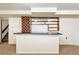 Close up of the basement bar showcases shelving and lighting, offering a great space for entertainment and relaxation at 10102 W Ida Ave # 214, Littleton, CO 80127