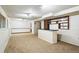 Spacious basement with a bar and built-in shelving, perfect for entertaining or creating a recreational area at 10102 W Ida Ave # 214, Littleton, CO 80127