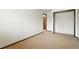 Neutral bedroom with large closet and open door, allowing for versatile furniture arrangements and customization at 10102 W Ida Ave # 214, Littleton, CO 80127