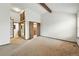 Bedroom with carpet, exposed beam, closet with ladder, mirrored closet, and view to bathroom at 10102 W Ida Ave # 214, Littleton, CO 80127