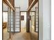 Hallway featuring dual mirrored closets, access to bathroom, ladder and custom wood features at 10102 W Ida Ave # 214, Littleton, CO 80127