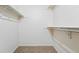 Walk-in closet with neutral carpet, white walls and wire racks for storage at 10102 W Ida Ave # 214, Littleton, CO 80127