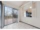Bright dining area with sliding glass door to deck and view into kitchen through shuttered windows at 10102 W Ida Ave # 214, Littleton, CO 80127