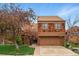 Charming two-story home featuring a two-car garage, unique wood shingle siding and front lawn at 10102 W Ida Ave # 214, Littleton, CO 80127