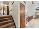Carpeted stairs lead to living space with vaulted ceilings, hardwood floors and custom wood features at 10102 W Ida Ave # 214, Littleton, CO 80127