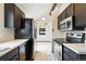 Updated kitchen features stainless steel appliances and dark cabinets with white countertops at 10102 W Ida Ave # 214, Littleton, CO 80127