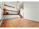 Spacious living room with cathedral ceilings, wood floors, staircase, and dining area at 10102 W Ida Ave # 214, Littleton, CO 80127