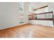 Bright living room with cathedral ceilings, wood floors, dining area, and natural light at 10102 W Ida Ave # 214, Littleton, CO 80127