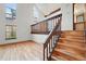 Open living room with wood floors, stairs, cathedral ceilings, and lots of natural light at 10102 W Ida Ave # 214, Littleton, CO 80127