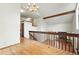 Loft boasts hardwood floors, exposed beam ceilings, and a wood banister overlooking living area at 10102 W Ida Ave # 214, Littleton, CO 80127