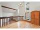View from the loft featuring hardwood floors, exposed beam, large windows, and brick fireplace at 10102 W Ida Ave # 214, Littleton, CO 80127