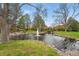 Community water feature is surrounded by lush green lawn and mature trees at 10102 W Ida Ave # 214, Littleton, CO 80127