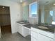 Main bathroom with double vanity and walk-in closet at 5598 Wisteria Ave, Firestone, CO 80504