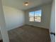 Upstairs bedroom with carpeted floor and window at 5598 Wisteria Ave, Firestone, CO 80504