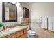Bathroom featuring neutral tile, a wood vanity, and a framed mirror at 11085 Huron St # 1108, Northglenn, CO 80234