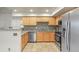 Well-lit kitchen with stainless steel appliances, mosaic backsplash, granite countertops, and wooden cabinetry at 11085 Huron St # 1108, Northglenn, CO 80234