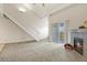 Bright living room with fireplace, balcony access, and staircase leading to the upper level at 11085 Huron St # 1108, Northglenn, CO 80234