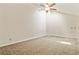 Large living room with plush carpet, ceiling fan, and neutral walls, creating a bright and inviting space at 11085 Huron St # 1108, Northglenn, CO 80234