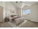 Bright main bedroom featuring vaulted ceilings, a plush bed, a neutral color palette and a sunny window at 11085 Huron St # 1108, Northglenn, CO 80234