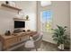Chic office space with desk, open shelving and a large window offering bright, natural light at 11085 Huron St # 1108, Northglenn, CO 80234