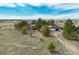 Aerial view of a property with a large yard, mature trees, and an oversized detached garage at 44626 Lariat Trl, Elizabeth, CO 80107