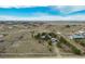 A rural property featuring an elevated lot with mature trees, an adjacent detached garage, and mountain views at 44626 Lariat Trl, Elizabeth, CO 80107
