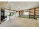 Spacious carpeted basement area featuring built-in shelving and wood-burning stove at 44626 Lariat Trl, Elizabeth, CO 80107