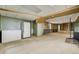 Large basement area with fridge, freezer, and built-in wooden shelves for storage at 44626 Lariat Trl, Elizabeth, CO 80107