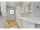 Bathroom features light wood floor, white cabinets, countertops, and trim at 44626 Lariat Trl, Elizabeth, CO 80107