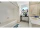 Bright bathroom with tub/shower combo and patterned floor tile at 44626 Lariat Trl, Elizabeth, CO 80107