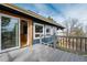 This open patio showcases a view of the home's sliding glass doors and black metal railing at 44626 Lariat Trl, Elizabeth, CO 80107