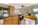 Bright kitchen featuring an island with seating, light wood cabinets, and stainless steel appliances at 44626 Lariat Trl, Elizabeth, CO 80107