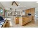 Open-concept kitchen featuring a large island, wood floors, and sun-filled window seating at 44626 Lariat Trl, Elizabeth, CO 80107