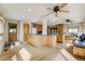 Well-lit kitchen with an island, hardwood floors, and access to the outdoor deck at 44626 Lariat Trl, Elizabeth, CO 80107