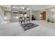Open living room with lots of natural light and light-colored carpet, plus a view into other rooms at 44626 Lariat Trl, Elizabeth, CO 80107