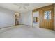 Living room with carpet flooring and natural woodwork throughout the doorway and the wooden door at 44626 Lariat Trl, Elizabeth, CO 80107