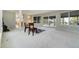Open-concept living space with neutral carpeting, sliding glass doors and decoratively placed chairs at 44626 Lariat Trl, Elizabeth, CO 80107