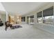 Spacious living room with neutral walls and carpet, offering views of the exterior patio at 44626 Lariat Trl, Elizabeth, CO 80107