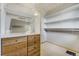 Walk-in closet features built-in wood drawers, shelves, and wire racks for maximum storage at 44626 Lariat Trl, Elizabeth, CO 80107