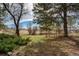Backyard with established lawn, landscaping and mature trees at 44626 Lariat Trl, Elizabeth, CO 80107