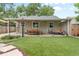Expansive backyard featuring manicured artificial turf, a covered patio with dining, and lounge seating at 4438 S Elati St, Englewood, CO 80110